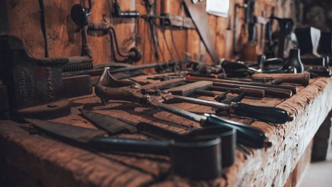 An organized woodworking workshop filled with tools and materials for crafting wood.